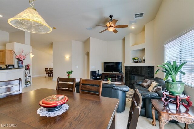 9524 Tyler Rose St, Las Vegas, NV 89178 - dining area with a ceiling fan, a tiled fireplace, and high vaulted ceiling