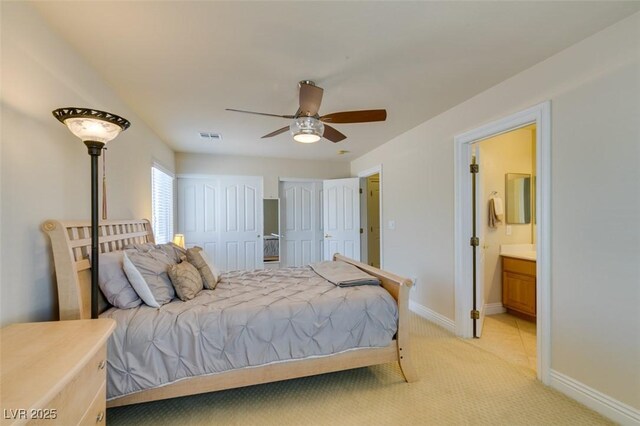 9524 Tyler Rose St, Las Vegas, NV 89178 - bedroom with two closets, light colored carpet, baseboards, connected bathroom, and a ceiling fan