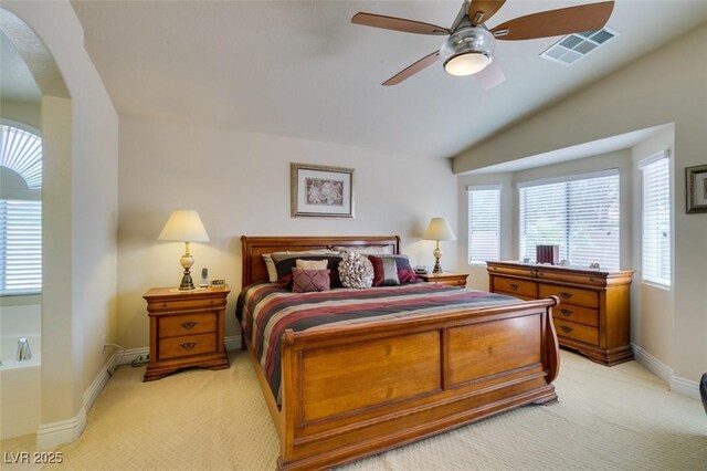 9524 Tyler Rose St, Las Vegas, NV 89178 - bedroom with light colored carpet, arched walkways, multiple windows, baseboards, and vaulted ceiling