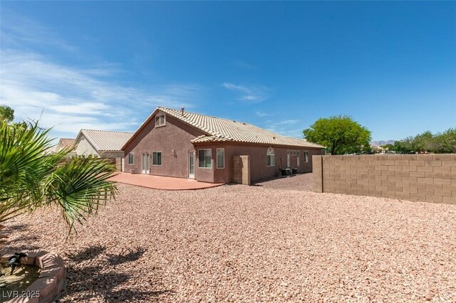 9524 Tyler Rose St, Las Vegas, NV 89178 - rear view of property featuring a tile roof, a patio, fence, and stucco siding
