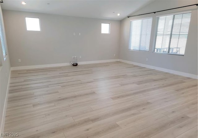 spare room with light wood-style floors, lofted ceiling, baseboards, and recessed lighting