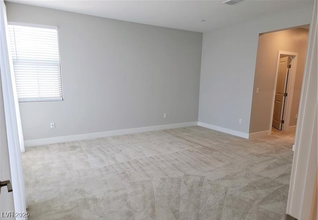 empty room with carpet flooring and baseboards