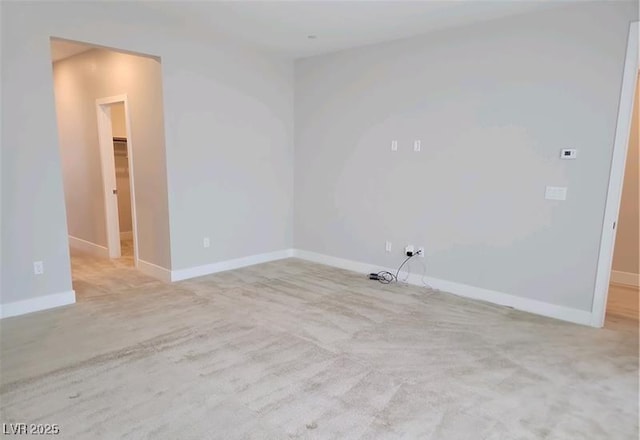 unfurnished room featuring baseboards and carpet flooring
