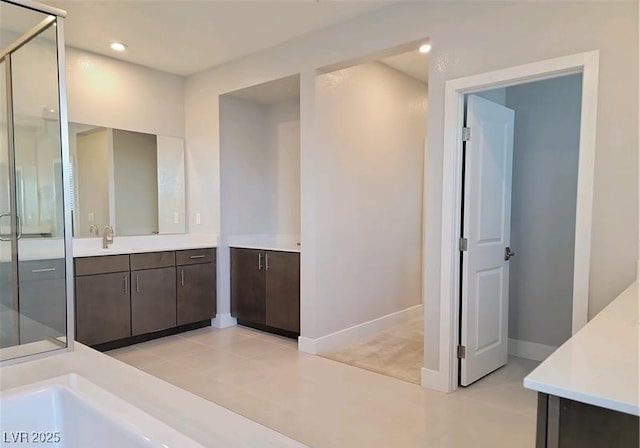 full bathroom with vanity, a shower stall, baseboards, recessed lighting, and tile patterned floors