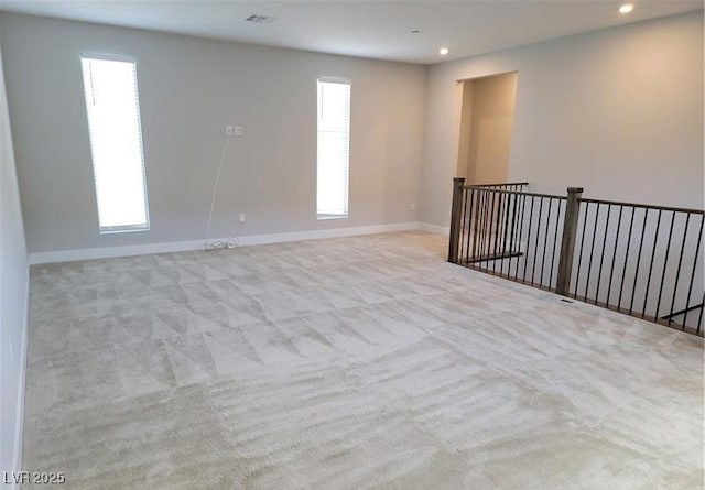 carpeted empty room with recessed lighting and baseboards