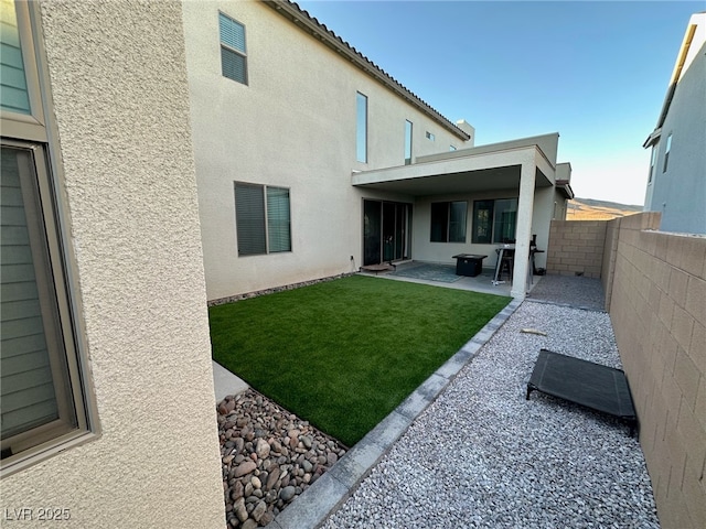 back of house featuring stucco siding and a patio
