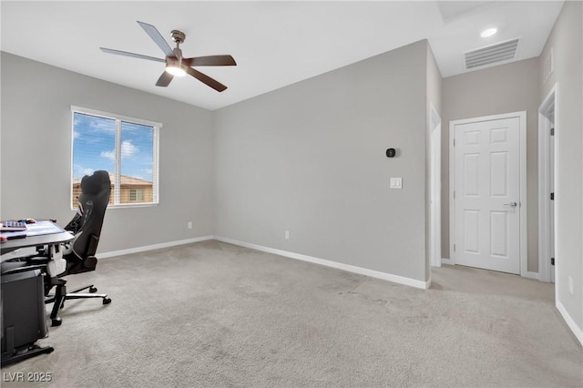 unfurnished office with carpet flooring, a ceiling fan, and baseboards
