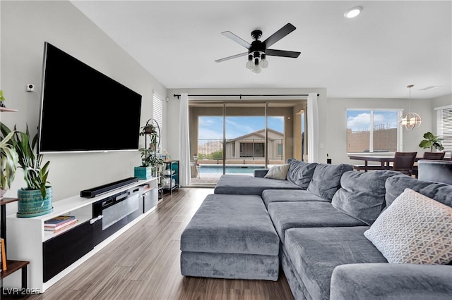 living area featuring ceiling fan, wood finished floors, a chandelier, and recessed lighting
