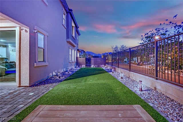 yard at dusk with a deck