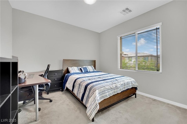 bedroom featuring light carpet, baseboards, and an office area