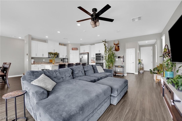 living room with a ceiling fan, baseboards, dark wood-style floors, and recessed lighting
