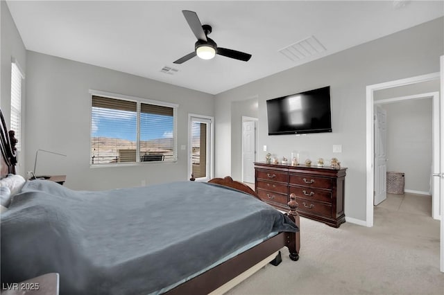 bedroom featuring baseboards, light colored carpet, and ceiling fan