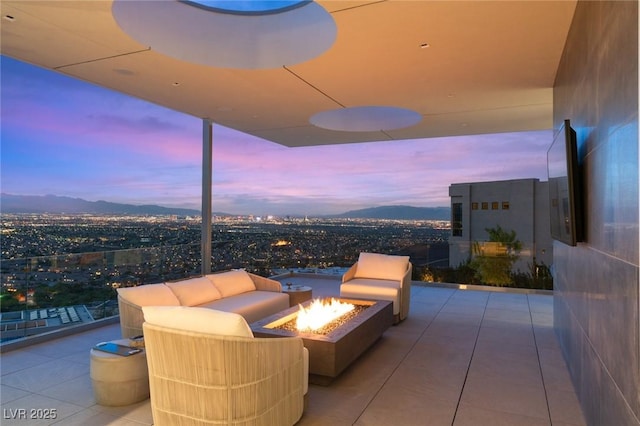13 Rockstream Dr, Henderson, NV 89012 - patio terrace at dusk featuring a fire pit and a mountain view