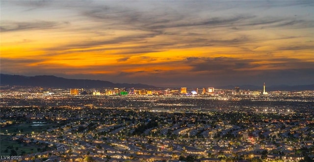 water view featuring nearby urban area and a mountain backdrop