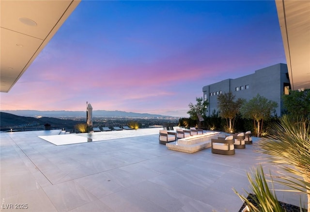 view of pool with a patio and a mountain view