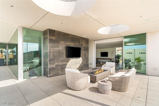 view of patio with an outdoor living space with a fire pit