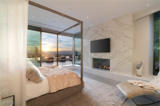 13 Rockstream Dr, Henderson, NV 89012 - bedroom with floor to ceiling windows, a premium fireplace, multiple windows, and access to outside