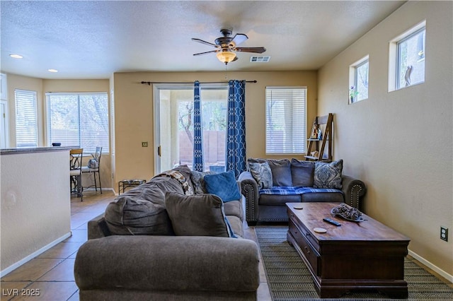 living area featuring a ceiling fan, baseboards, tile patterned flooring, and recessed lighting