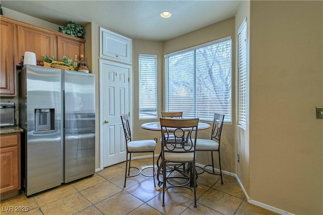 dining area featuring light tile patterned flooring, baseboards, and recessed lighting