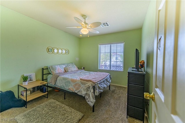 carpeted bedroom featuring baseboards and a ceiling fan