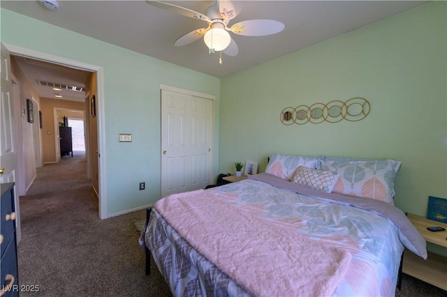carpeted bedroom with ceiling fan, baseboards, and a closet