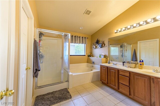 full bathroom featuring lofted ceiling, a garden tub, tile patterned floors, a shower stall, and double vanity