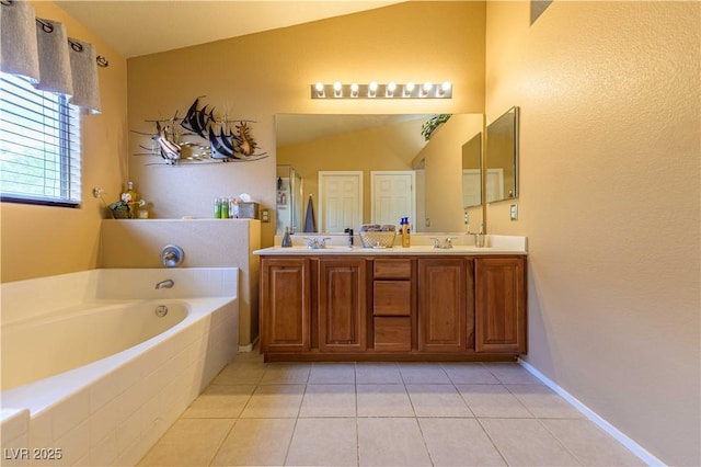 bathroom with a bath, tile patterned flooring, a stall shower, double vanity, and lofted ceiling