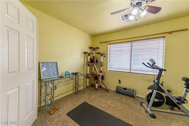 workout area featuring a ceiling fan, carpet, and baseboards