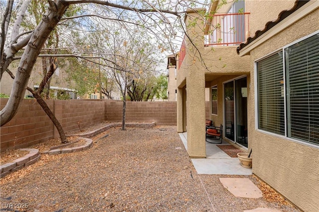 fenced backyard with a patio area