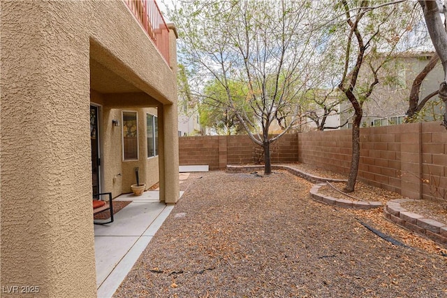 fenced backyard with a patio area