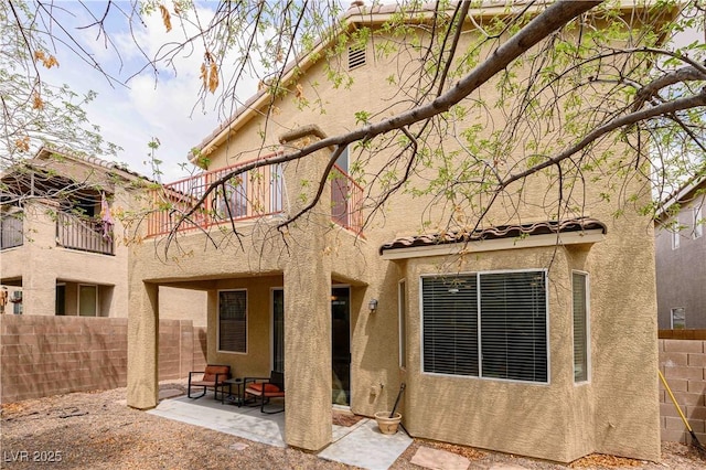 back of house with a patio, stucco siding, and fence