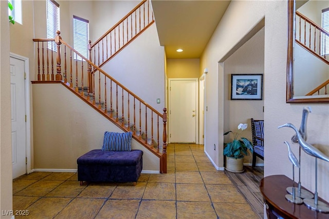 foyer featuring stairs, baseboards, recessed lighting, and tile patterned floors