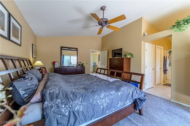 bedroom with vaulted ceiling, carpet floors, and tile patterned floors
