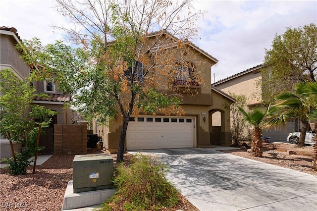 view of front of house featuring stucco siding, concrete driveway, and a tile roof