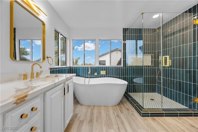575 Dusty Palms Ln, Henderson, NV 89052 - bathroom with healthy amount of natural light, vanity, a freestanding bath, a shower stall, and tile walls