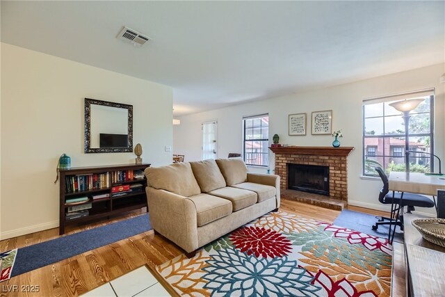 5576 W Rochelle Ave Unit 27C, Las Vegas, NV 89103 - living room featuring wood finished floors, baseboards, and a fireplace