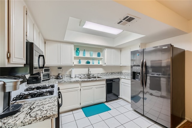 5576 W Rochelle Ave Unit 27C, Las Vegas, NV 89103 - kitchen featuring black appliances, a raised ceiling, a sink, and white cabinetry