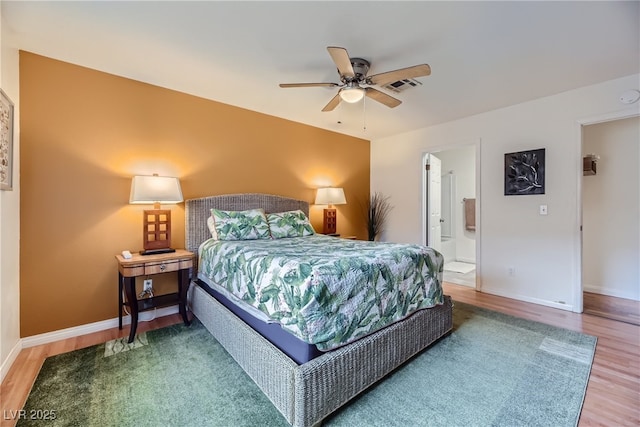 5576 W Rochelle Ave Unit 27C, Las Vegas, NV 89103 - bedroom featuring wood finished floors, baseboards, ensuite bath, and ceiling fan