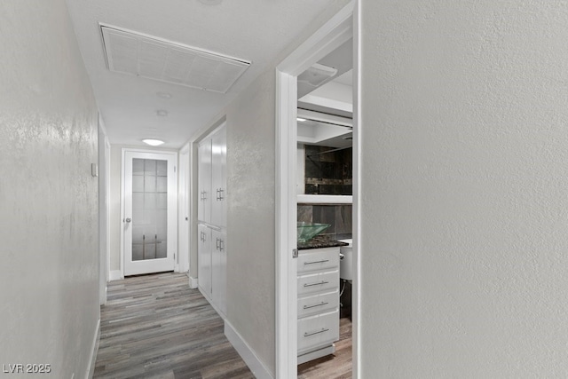 hall with wood finished floors and baseboards