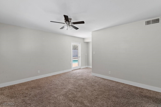 spare room with a ceiling fan, carpet floors, and baseboards