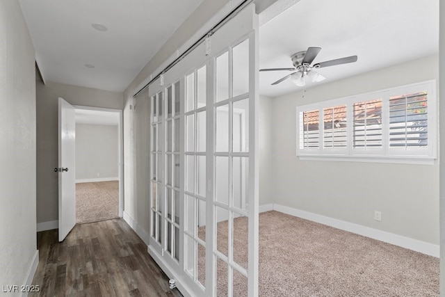 corridor featuring baseboards and dark wood-type flooring