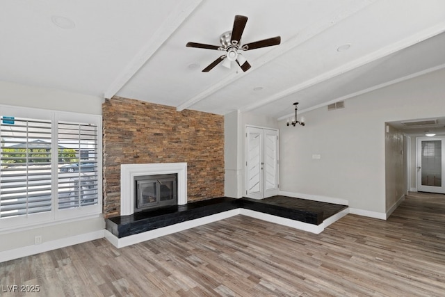 unfurnished living room with wood finished floors, baseboards, ceiling fan, and a glass covered fireplace
