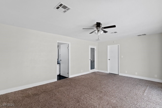 spare room with dark colored carpet, a ceiling fan, and baseboards