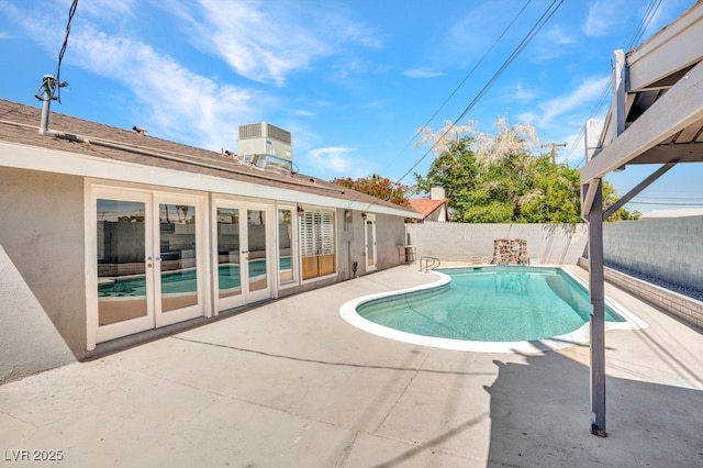 view of swimming pool with a patio, a fenced backyard, and french doors