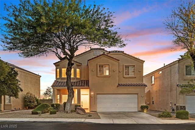 1221 Diamond Valley St, Henderson, NV 89052 - mediterranean / spanish house with a tile roof, an attached garage, driveway, and stucco siding