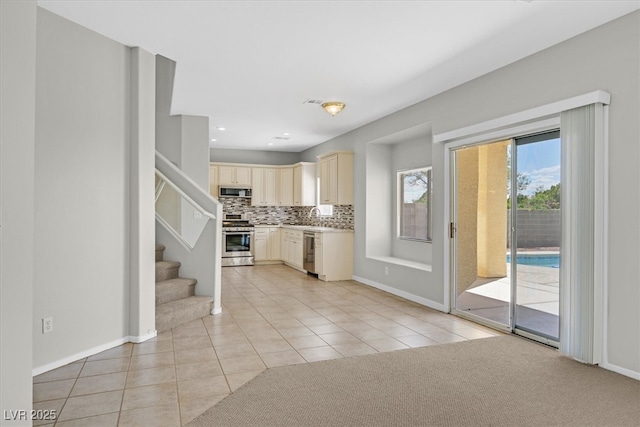 1221 Diamond Valley St, Henderson, NV 89052 - kitchen with appliances with stainless steel finishes, cream cabinets, light tile patterned flooring, a sink, and recessed lighting