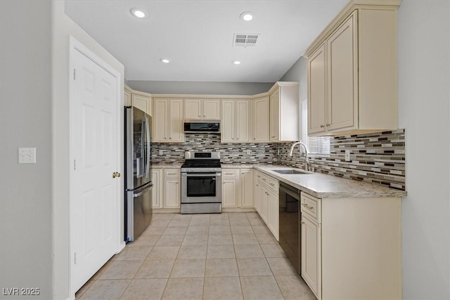 1221 Diamond Valley St, Henderson, NV 89052 - kitchen featuring appliances with stainless steel finishes, a sink, cream cabinetry, backsplash, and recessed lighting