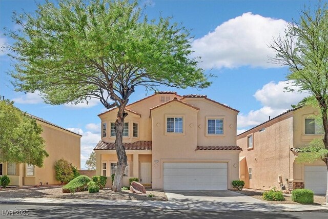 1221 Diamond Valley St, Henderson, NV 89052 - mediterranean / spanish home featuring a tile roof, an attached garage, driveway, and stucco siding