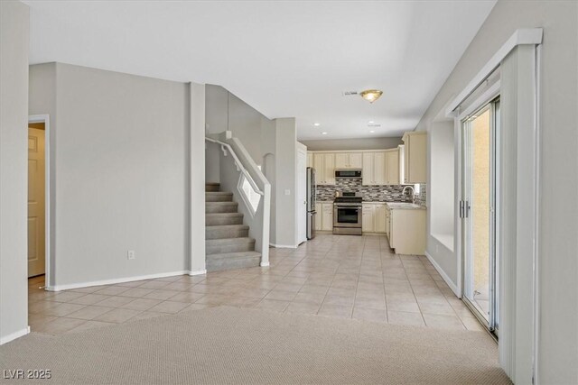 1221 Diamond Valley St, Henderson, NV 89052 - kitchen featuring appliances with stainless steel finishes, light tile patterned flooring, backsplash, a sink, and light countertops