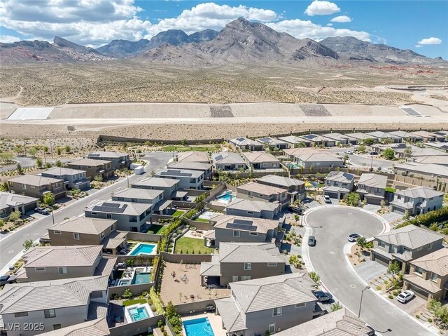 12429 Alpenglow Ct, Las Vegas, NV 89138 - aerial view of residential area featuring a mountain backdrop and a pool area
